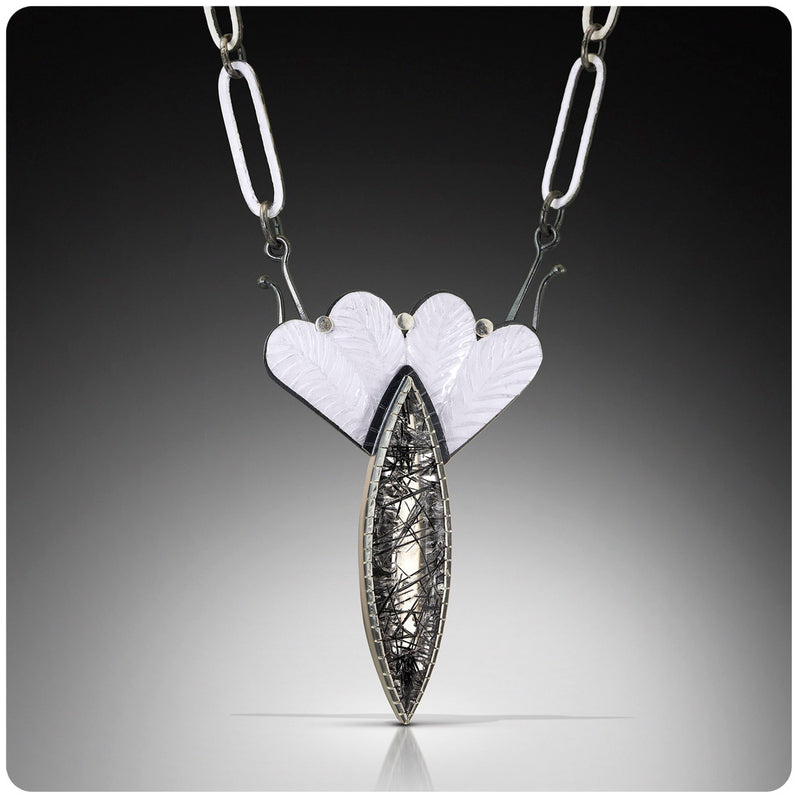 Rutilated quartz and enamel pendant.